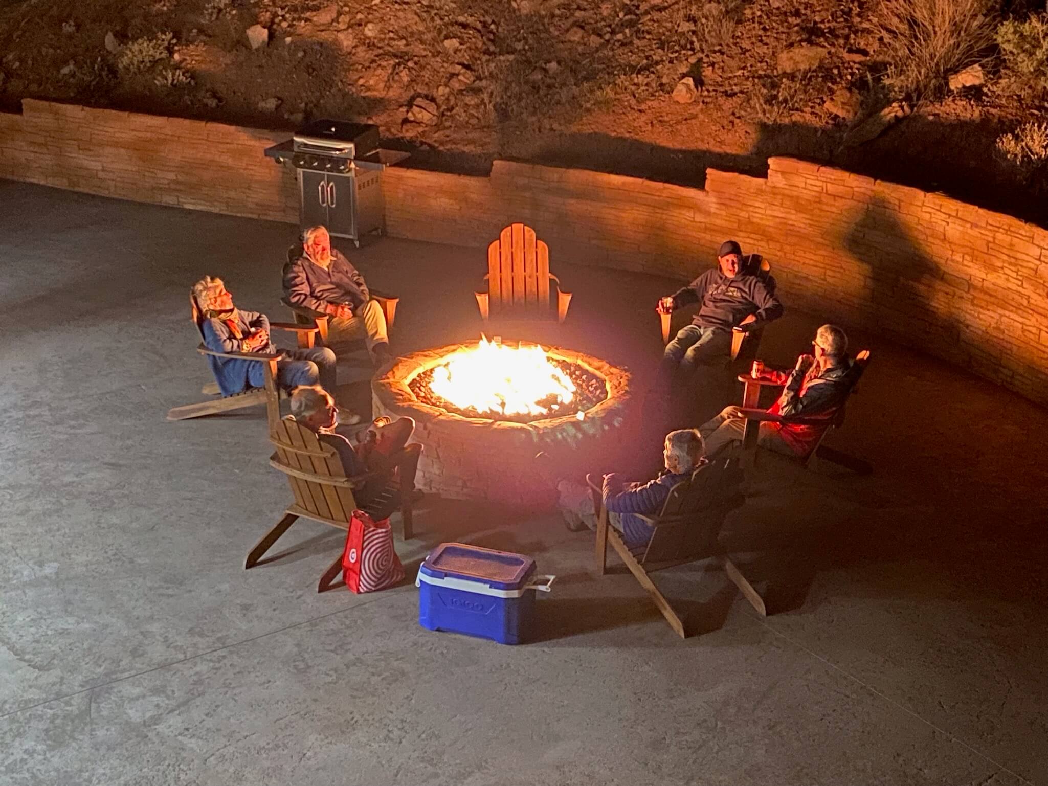 Tour group enjoying an evening around a kiva at Bluff Dwelling
